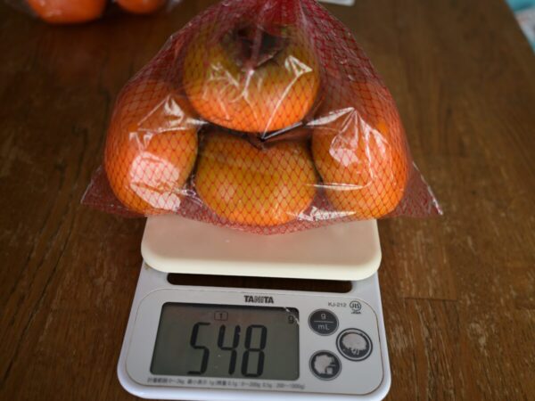 串柿の里付近の無人販売所の柿の量が548gと表示された画像